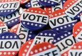 pile of red, white, and blue vote buttons