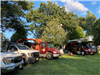 Division of public works trucks and vehicles lined up on grassy park area