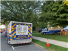 EMS vehicles parked next to and on grassy park area