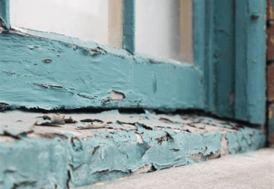 a window with peeling blue paint