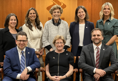 a group of councilmembers sit in Summit NJ Council Chamber and pose for a group photo