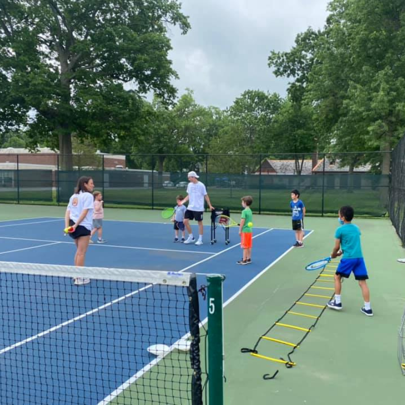 kids playing tennis on tennis court