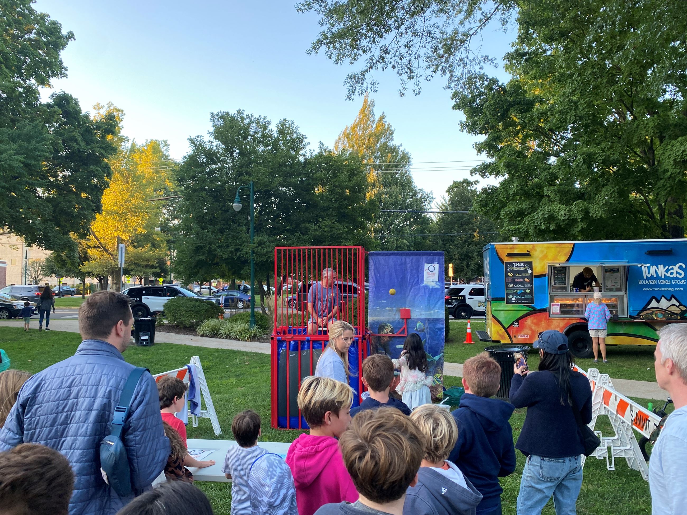 Children and adults waiting in line for dunk tank game