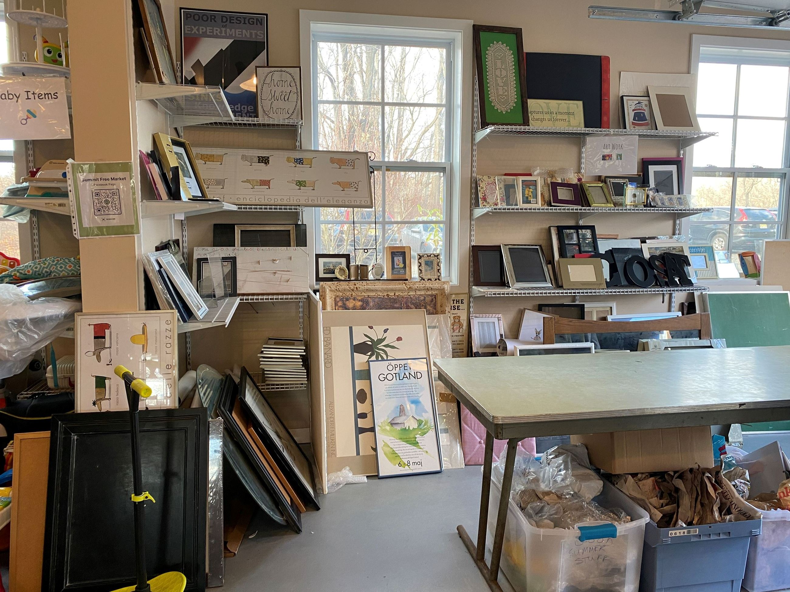 frames on garage shelves and tables at summit free market building