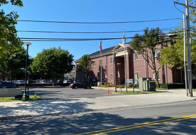 image of the outside of city hall from across springfield avenue, you can see the parking lot, a car