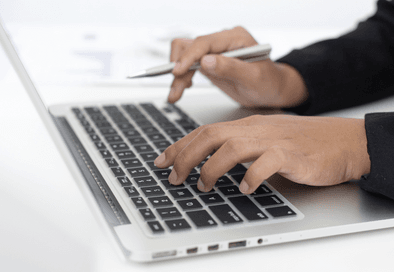 image of someone's hands at an open laptop