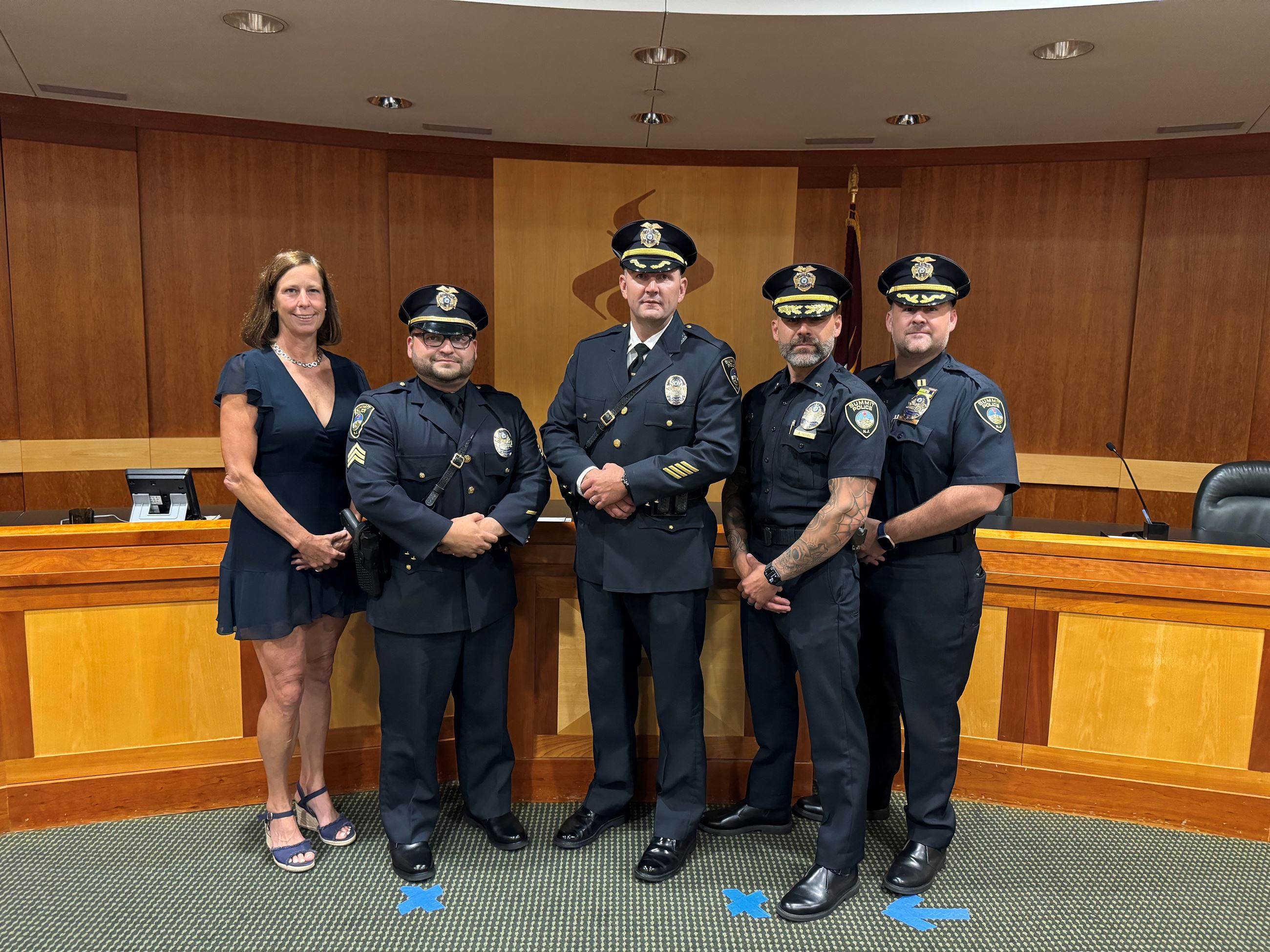 police officers and mayor in council chamber